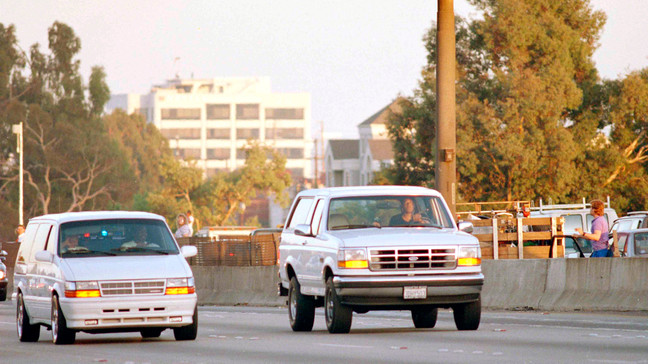 FILE - Al Cowlings, with O.J. Simpson hiding, drives a white Ford Bronco as they lead police on a two-county chase along the northbound 405 Freeway towards Simpson's home, June 17, 1994, in Los Angeles. (AP Photo/Lois Bernstein, File)
