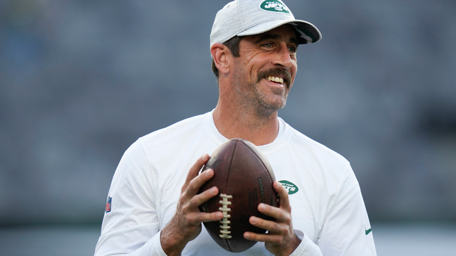 FILE - New York Jets quarterback Aaron Rodgers walks on the field during warm-ups before an NFL football game against the Tampa Bay Buccaneers, Saturday, Aug. 19, 2023, in East Rutherford, N.J. Heâll become a folk hero if he can lead the Jets to a Super Bowl for the first time since Broadway Joe Namath.(AP Photo/Seth Wenig, File)