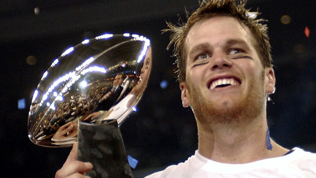 FILE - In this Feb. 1, 2004, file photo, New England Patriots quarterback Tom Brady holds the Vince Lombardi Trophy after the Patriots beat the Carolina Panthers 32-29 in Super Bowl 38 in Houston. Brady, who won a record seven Super Bowls for New England and Tampa, has announced his retirement, Wednesday, Feb. 1, 2023. (AP Photo/Dave Martin, File)