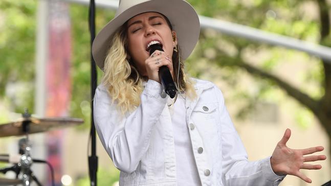 FILE - In this May 26, 2017 file photo, singer Miley Cyrus performs on NBC's "Today" show in New York. Cyrus will join Ariana Grande at a charity concert called "One Love Manchester" in Manchester, England, Sunday, June 3, 2017, two weeks after a bomber killed 22 people at Grande's concert in Manchester. (Photo by Evan Agostini/Invision/AP, File)