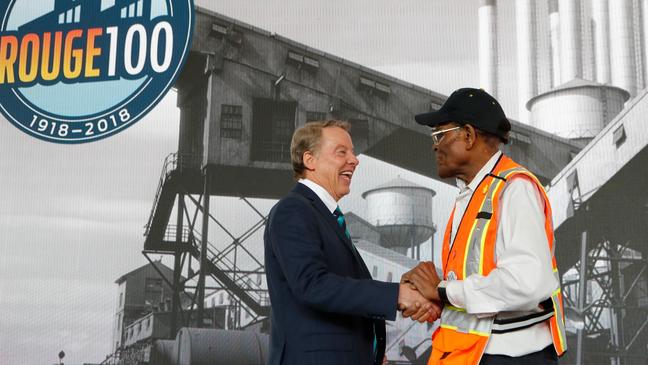 Ford Motor Co., Executive Chairman Bill Ford, left, shakes hands with Willie Fulton, a 65-year employee of the Ford Rouge plant, Thursday, Sept. 27, 2018, in Dearborn, Mich. Ford is celebrating a century of production at its storied Rouge factory in Dearborn, and made an announcement about the plant's future at a ceremony Thursday. (AP Photo/Carlos Osorio)