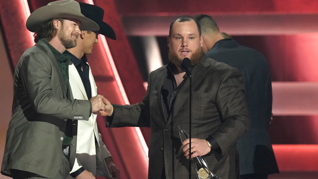 FILE - Presenter Brian Kelley, left, shakes hands with Luke Combs as he appears on stage to accept the award for single of the year for "Fast Car" at the 57th Annual CMA Awards on Wednesday, Nov. 8, 2023, at the Bridgestone Arena in Nashville, Tenn. (AP Photo/George Walker IV)