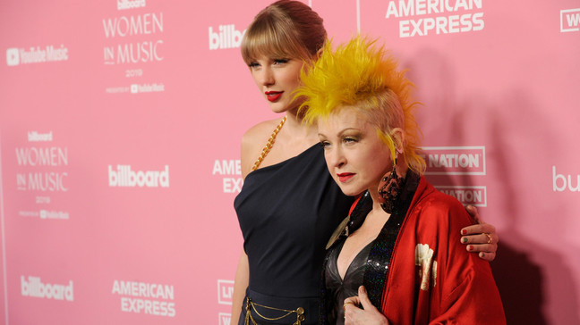 Taylor Swift, left, and Cyndi Lauper arrive at Billboard's Women in Music at the Hollywood Palladium on Thursday, Dec. 12, 2019, in Los Angeles. (AP Photo/Chris Pizzello)