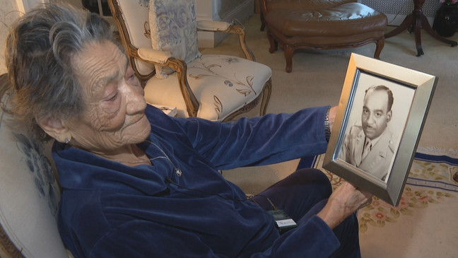 Fleming looks at a picture of her late husband. (WJAR)