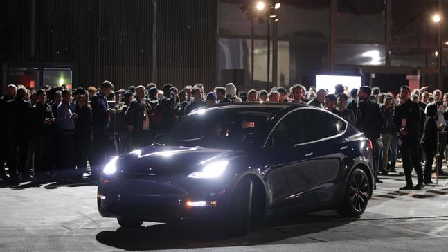 People wait outside Tesla's design studio for a test drive of the Model Y, Thursday, March 14, 2019, in Hawthorne, Calif. (AP Photo/Jae C. Hong)