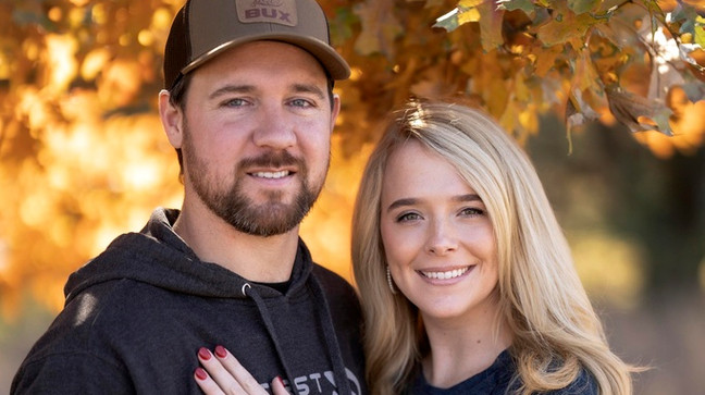 Cole Bures proposes to Samantha Camenzind during a photo shoot after she shot and killed a giant buck during a deer hunt on Nov. 12 , 2023 near Filley, Neb.. Bures surprised his future bride by popping the question after she bagged the deer. (Brenton Lammers/Lammers Media via AP)