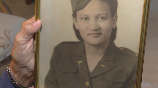 Fleming shows a photo of herself as a nurse in the armed services. (WJAR)