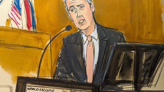 Michael Cohen testifies on the witness stand with a National Enquirer cover story about Donald Trump displayed on a screen in Manhattan criminal court, Monday, May 13, 2024, in New York. (Elizabeth Williams via AP)