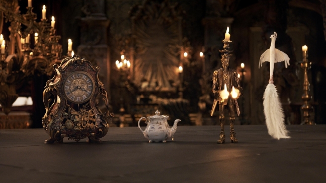 The mantel clock Cogsworth, the teapot Mrs. Potts, Lumiere the candelabra, and the feather duster Plumette live in an enchanted castle in Disney's "Beauty and the Beast," the live-action adaptation of the studio's animated classic directed by Bill Condon. (Disney)
