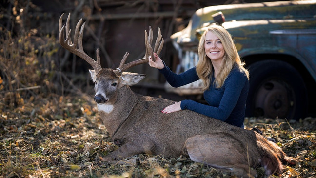 Samantha Camenzind poses with the deer she shot near Filley, Neb., before Cole Bures proposed to her on Nov. 12, 2023. Bures asked Camenzind to marry him during a photo shoot to commemorate the moment. (Brenton Lammers/Lammers Media via AP)