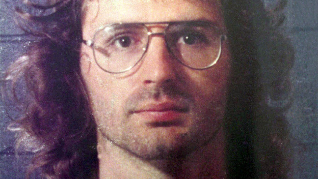 Waco: American Apocalypse. David Koresh in Waco: American Apocalypse. Cr. Waco Tribune Herald/Courtesy of Netflix © 2023. McLennan Country Sheriff office of David Koresh 1988 booking for assault on Branch Davidian Cult before the compound was built.
