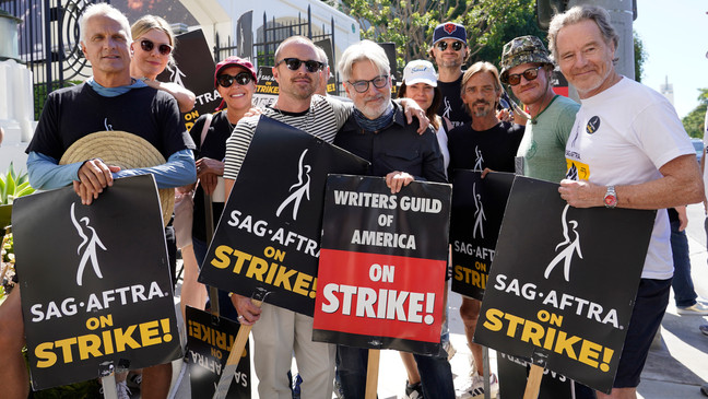 Cast and writers from "Breaking Bad" and "Better Call Saul" pose on a picket line outside Sony Pictures studios on Tuesday, Aug. 29, 2023, in Culver City, Calif. (AP Photo/Chris Pizzello)