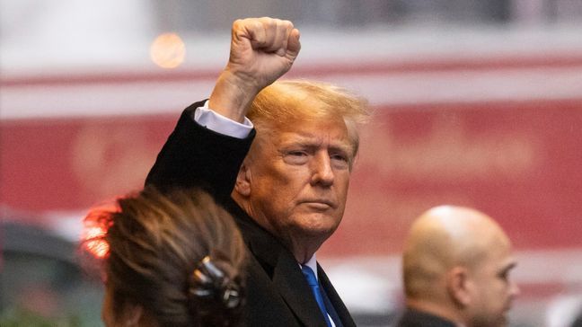 Former President Donald Trump raises his fist as he leaves his apartment building, Thursday, Jan 25, 2024, in New York. (AP Photo/Yuki Iwamura)