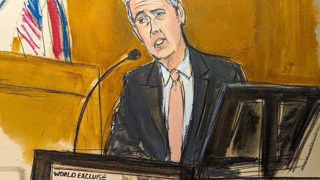 Michael Cohen testifies on the witness stand with a National Enquirer cover story about Donald Trump displayed on a screen in Manhattan criminal court, Monday, May 13, 2024, in New York. (Elizabeth Williams via AP)