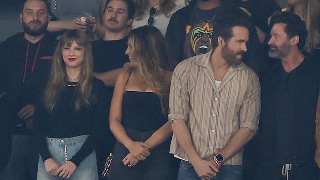 FILE - In front, from left, Taylor Swift, Blake Lively and Ryan Reynolds stand for the national anthem before an NFL football game between the New York Jets and the Kansas City Chiefs, Sunday, Oct. 1, 2023, in East Rutherford, N.J. (AP Photo/Adam Hunger)