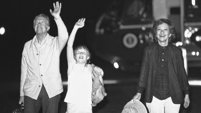 FILE - President Jimmy Carter, daughter Amy and first lady Rosalynn Carter wave to a group of people waiting on the Truman balcony of the White House in Washington, July 2, 1979 as the Carters arrive after their trip to Tokyo and South Korea.{&nbsp;} (AP Photo, file)