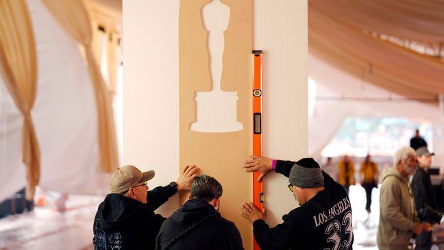 Crew members prepare the red carpet area on Wednesday, March 6, 2024, for Sunday's 96th Academy Awards at the Dolby Theatre in Los Angeles. (AP Photo/Chris Pizzello)