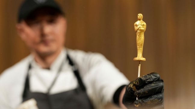 Junghoon Pak presents a chocolate statue during the Governors Ball press preview for the 96th Academy Awards, Tuesday, March 5, 2024, in Los Angeles. The Academy Awards will be held on Sunday, March 10. (Photo by Jordan Strauss/Invision/AP)