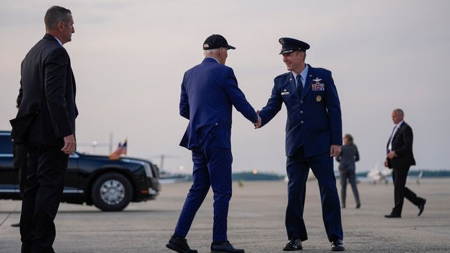 President Joe Biden is greeted by Col. Gregory Adams, Commander of the 89th Operations Group, as he arrives to board Air Force One for a trip to France to mark the 80th anniversary of D-Day, Tuesday, June 4, 2024, in Andrews Air Force Base, Md. (AP Photo/Evan Vucci)