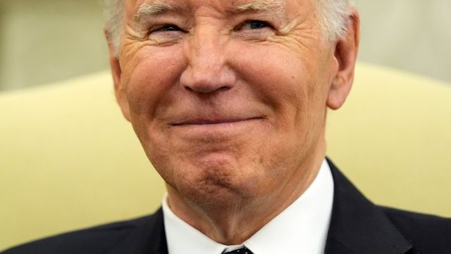 President Joe Biden smiles as he meets with Romania's President Klaus Iohannis in the Oval Office of the White House, Tuesday, May 7, 2024, in Washington. (AP Photo/Alex Brandon)