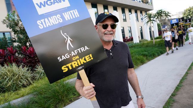 FILE - Writer Matthew Weiner carries a sign on the picket line outside Netflix on Wednesday, Sept. 27, 2023, in Los Angeles. (AP Photo/Chris Pizzello)