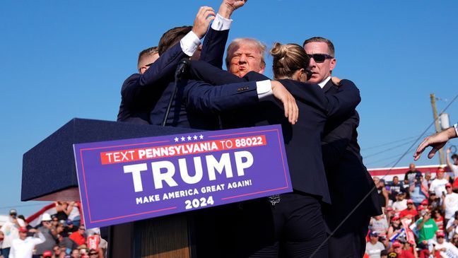 Republican presidential candidate former President Donald Trump is surrounded by U.S. Secret Service agents at a campaign rally, Saturday, July 13, 2024, in Butler, Pa. (AP Photo/Evan Vucci)