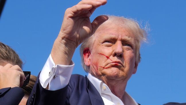 Republican presidential candidate former President Donald Trump waves from the stage as he is surrounded by U.S. Secret Service agents at a campaign rally, Saturday, July 13, 2024, in Butler, Pa. (AP Photo/Evan Vucci)