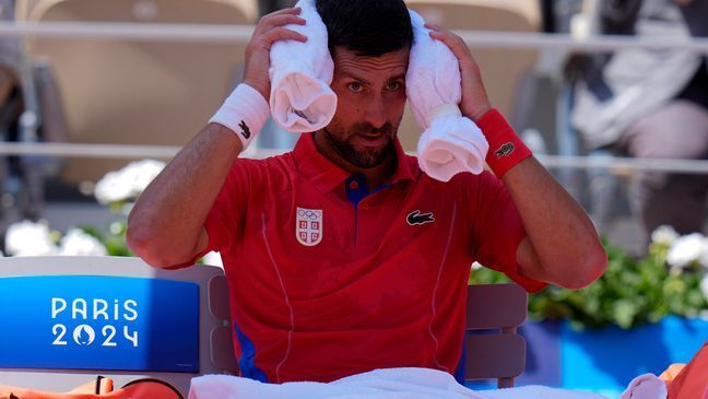 Serbia's Novak Djokovic cools off during a break as he plays Spain's Rafael Nadal during their men's singles second round match at the 2024 Summer Olympics, Monday, July 29, 2024, at the Roland Garros stadium in Paris, France. (AP Photo/Andy Wong)