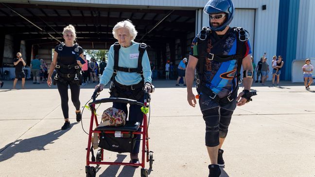 FILE - Dorothy Hoffner, 104, walks out to the plane with tandem jumper Derek Baxter as she becomes the oldest person in the world to skydive Sunday, Oct. 1, 2023, at Skydive Chicago in Ottawa, Ill. (Brian Cassella/Chicago Tribune via AP)