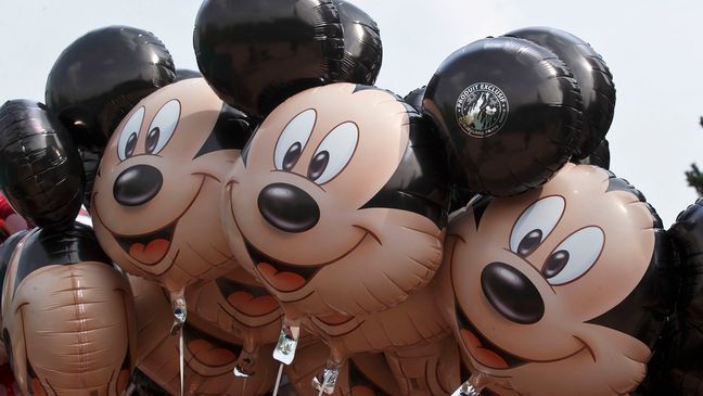 FILE - Mickey Mouse balloons appear at Disneyland Paris, May 12, 2015, in Chessy, France, east of Paris.{&nbsp;} (AP Photo/Michel Euler, File)