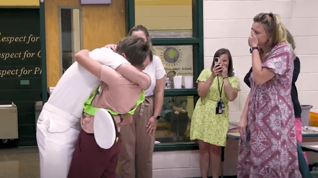 Ethan, a fifth-grade student at Rosa Parks Elementary School, embraces his father during a surprise reunion. (Photo courtesy of Prince William County Schools)