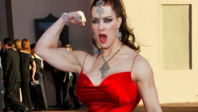 FILE - In this Nov. 16, 2003 file photo, Joanie Laurer, former pro wrestler known as Chyna, flexes her bicep as she arrives at the 31st annual American Music Awards, in Los Angeles. (AP Photo/Kevork Djansezian)