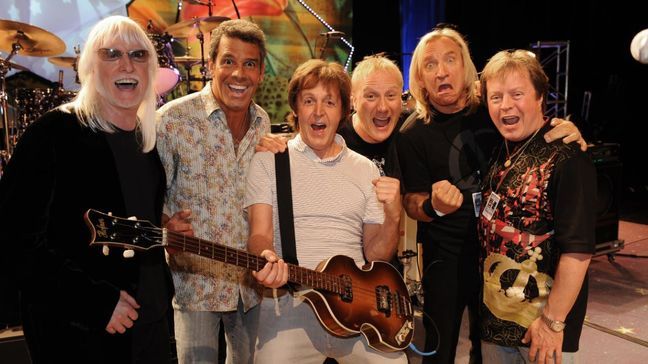 Mark Rivera, second from left, is shown with Sir Paul McCartney, middle, during one of his stints as musical director of Ringo Starr's All-Starr Band. (Left to right) Edgar Winter, Mark Rivera, Paul McCartney, Greg Bissonette, Joe Walsh, Rick Derringer. (PHOTO: Rob Shanahan)