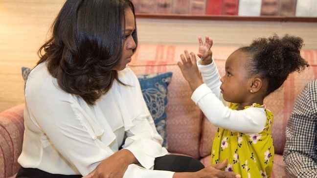 Former First Lady Michelle Obama meets with two-year-old Parker Curry on Tuesday, March 6, 2018, whose photo went viral showing her awe-struck by the portrait of Michelle Obama at the National Portrait Gallery. (Photo courtesy of mother Jessica Curry){p}{/p}