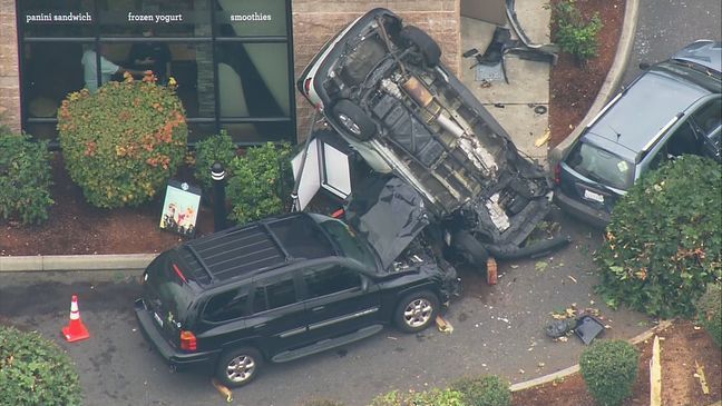 An SUV sits upside-down after crashing through a Starbucks drive-thru line in Puyallup on Aug. 9, 2016. (Photo: KOMO News/Air 4).