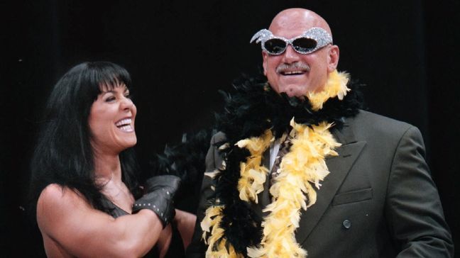 FILE - In this July 14, 1999 file photo, Minnesota Gov. Jesse Ventura is adorned with his signature feather boa and glitter sunglasses by professional wrestler Chyna, during a World Wrestling Federation press conference at the Target Center in Minneapolis. (AP Photo/Dawn Villella, File)