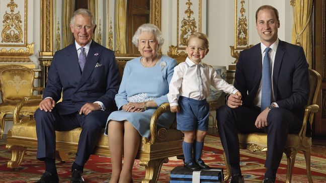 In this image released by the Royal Mail on Wednesday April 20, 2016, Britain's Prince George stands on foam blocks during a photo shoot for the Royal Mail in the summer of 2015 in the White Drawing Room at Buckingham Palace in London for a stamp sheet to mark the 90th birthday of Britain's Queen Elizabeth II.  The image features four generations of the Royal family, from left, Prince Charles, Queen Elizabeth II, Prince George and Prince William, the Duke of Cambridge. (Ranald Mackechnie/Royal Mail via AP) MANDATORY CREDIT