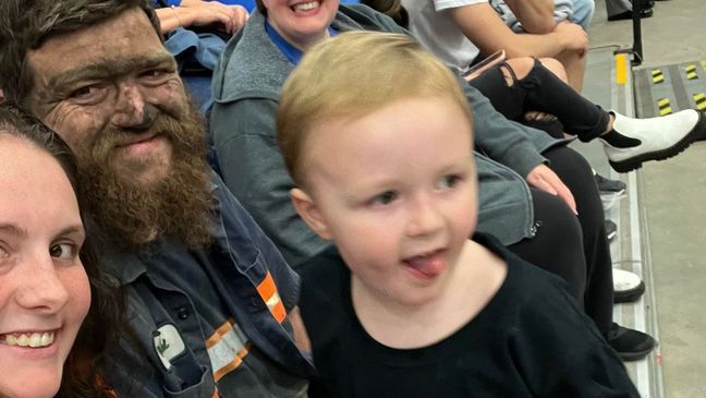 Photo of Kentucky coal miner taking son to UK basketball game after work goes viral (Credit: Mollie McGuire)