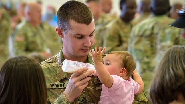 Staff Sergeant John Wright holds his eight-month-old daughter, Maci Danielle for the first time. Wright said he used FaceTime to stay in touch with his family during the deployment. (Stephen Quinn | abc3340.com)