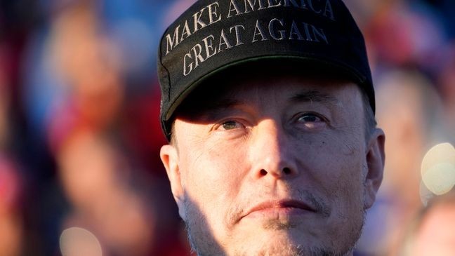 Tesla and SpaceX CEO Elon Musk listens as Republican presidential nominee former President Donald Trump speaks at a campaign event at the Butler Farm Show, Saturday, Oct. 5, 2024, in Butler, Pa. (AP Photo/Alex Brandon)