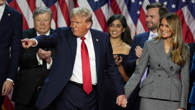 Republican Presidential nominee former President Donald Trump holds hands with former first lady Melania Trump after speaking to supporters at the Palm Beach County Convention Center during an election night watch party, Wednesday, Nov. 6, 2024, in West Palm Beach, Fla. (AP Photo/Lynne Sladky)