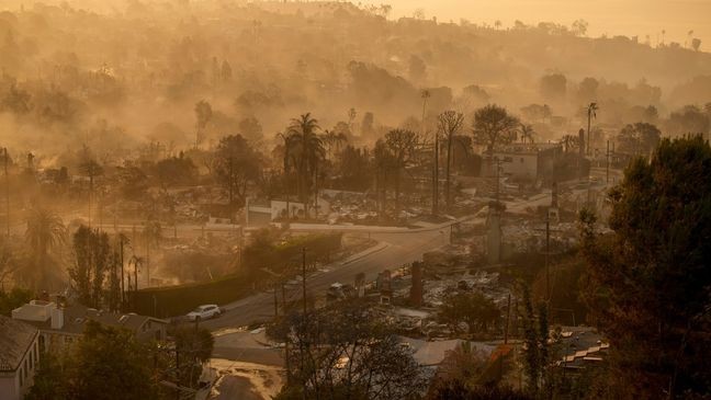 The devastation of the Palisades Fire is seen in the early morning in the Pacific Palisades neighborhood of Los Angeles, Friday, Jan. 10, 2025. (AP Photo/John Locher)