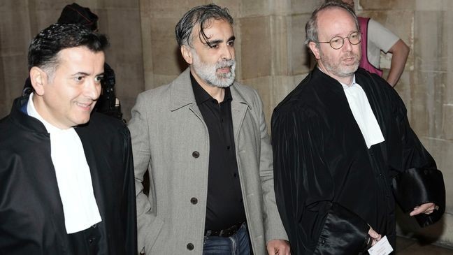 Abderrahmane Ouatiki, center, who was working as a hotel receptionist, is flanked by his lawyers Mohand Ouidja, left, and Henri De Beauregard during the trial of the 2016 armed robbery of Kim Kardashian, at the palace of justice, Tuesday, May 13, 2025 in Paris. (AP Photo/Aurelien Morissard)