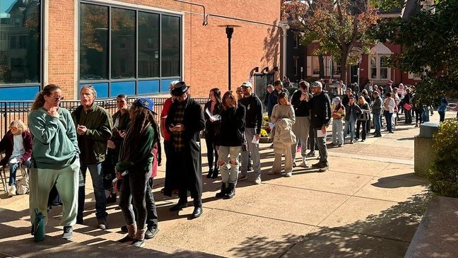 People wait in line outside the Bucks County government building to apply for an on-demand mail ballot on the last day to request one in Doylestown, Pa., Tuesday, Oct. 29, 2024. (AP Photo/Mike Catalini)