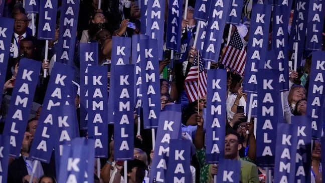 Delegates hold signs as Democratic presidential nominee Vice President Kamala Harris speaks during the Democratic National Convention Thursday, Aug. 22, 2024, in Chicago. (AP Photo/Brynn Anderson)