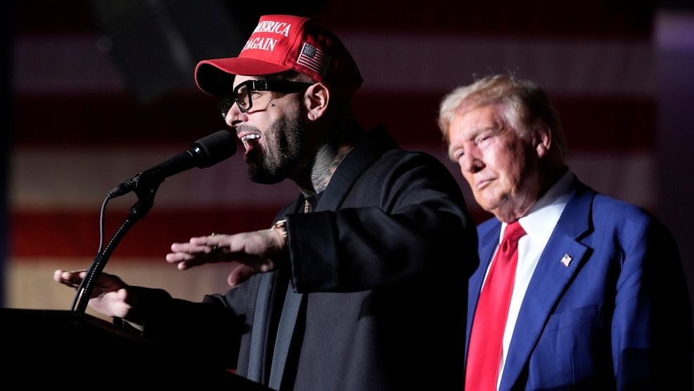 Nicky Jam speaks as Republican presidential nominee former President Donald Trump listens during a campaign event at the World Market Center, Friday, Sept.13, 2024, in Las Vegas. (AP Photo/Alex Brandon)