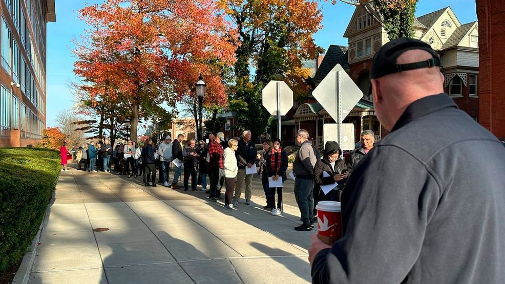 People wait in line outside the Bucks County government building to apply for an on-demand mail ballot on the last day to request one in Doylestown, Pa., Tuesday, Oct. 29, 2024. (AP Photo/Mike Catalini)