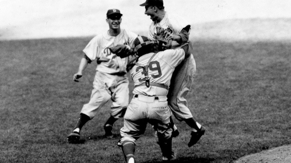 FILE - Brooklyn Dodgers pitcher Johnny Podres is lifted by catcher Roy Campanella (39) after the final out of the seventh and deciding game of the World Series at Yankee Stadium, Oct. 4, 1955, in New York. (AP Photo, File)