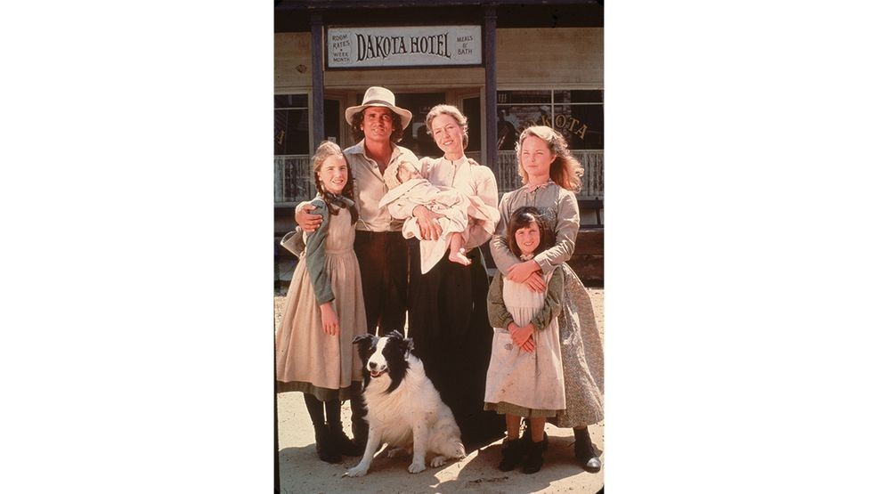 The cast of the television series 'Little House on the Prairie' with a dog on the set of the show, mid 1970s. Clockwise from left: American actors Melissa Gilbert, Michael Landon (1936 - 1991), Karen Grassle, who holds an unidentified baby, Melissa Sue Anderson, and Lindsay or Sidney Greenbush. (Photo by Fotos International/Getty Images)