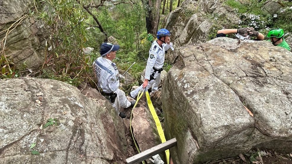 Image for story: Woman rescued after spending hours 'hanging by her feet' between boulders 